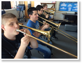 A row of trombone players
